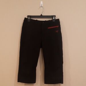 Arc'teryx Cropped Rock Black Pants with Red Accents.